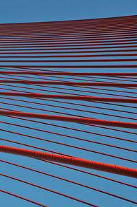 Full frame shot of red metallic structure against blue sky