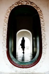 Rear view of silhouette woman walking in building