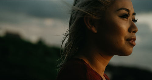 Close-up portrait of young woman looking away