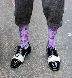 Low section of woman standing on street