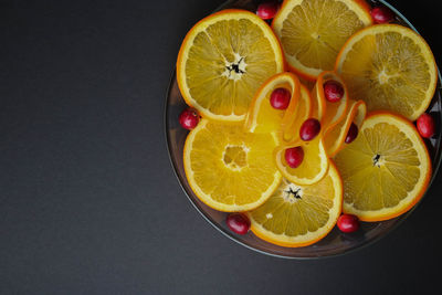 High angle view of fruits in glass over black background