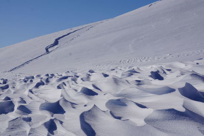 Scenic view of snow covered mountain against clear sky