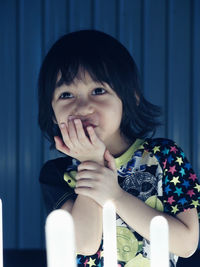 Close-up portrait of boy with hand on chin