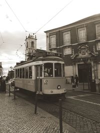 View of railroad tracks by buildings in city