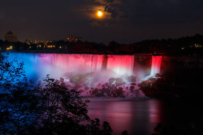 Scenic view of river against sky at night