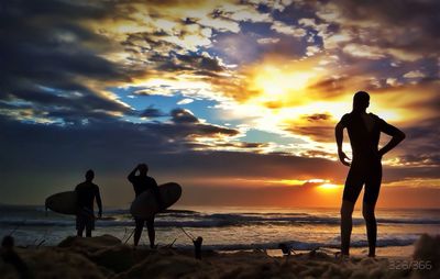 Silhouette of people at beach during sunset