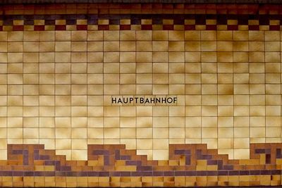 Close-up of text on brick wall