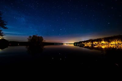 Scenic view of lake against sky at night