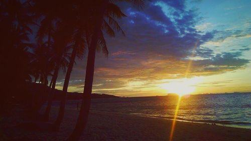 Scenic view of beach against sky during sunset