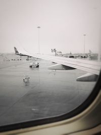 Airplane on airport runway against clear sky