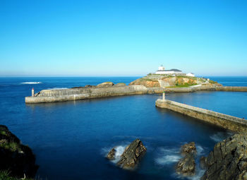 Scenic view of sea against clear blue sky