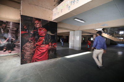 People walking in corridor of building