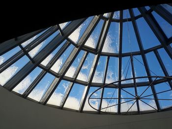 Low angle view of skyscraper against blue sky