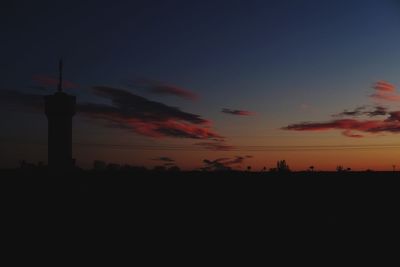 Low angle view of silhouette tower against sky at night