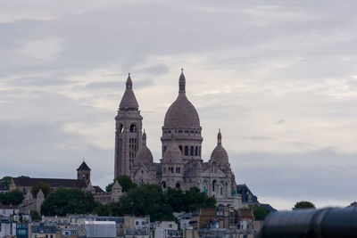 Buildings in city against sky