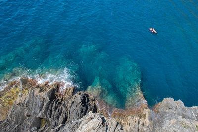 High angle view of rock formations by sea