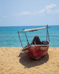 Boat on beach against sky
