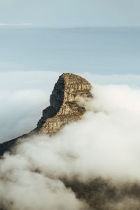 Rock formations in sea against sky