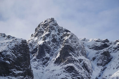 Low angle view of snowcapped mountain against sky