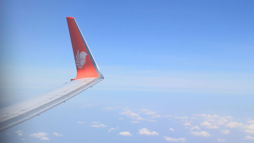 Low angle view of airplane flying against sky