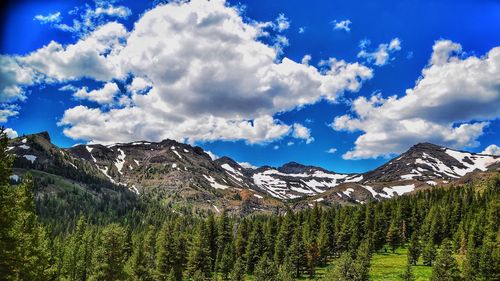 Scenic view of mountains against blue sky