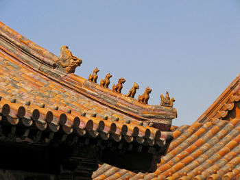 Low angle view of statues on roof