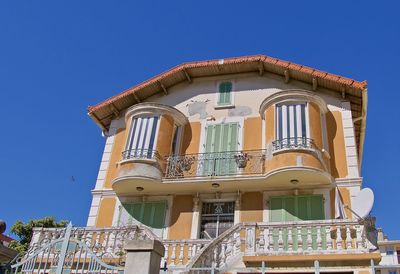 Low angle view of building against clear blue sky