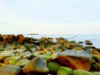 Rocks on beach against sky