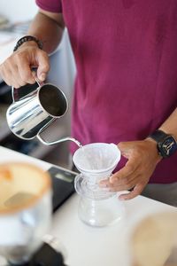 High angle view of barista making coffee in cafe