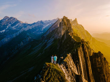 Panoramic view of people on mountain against sky