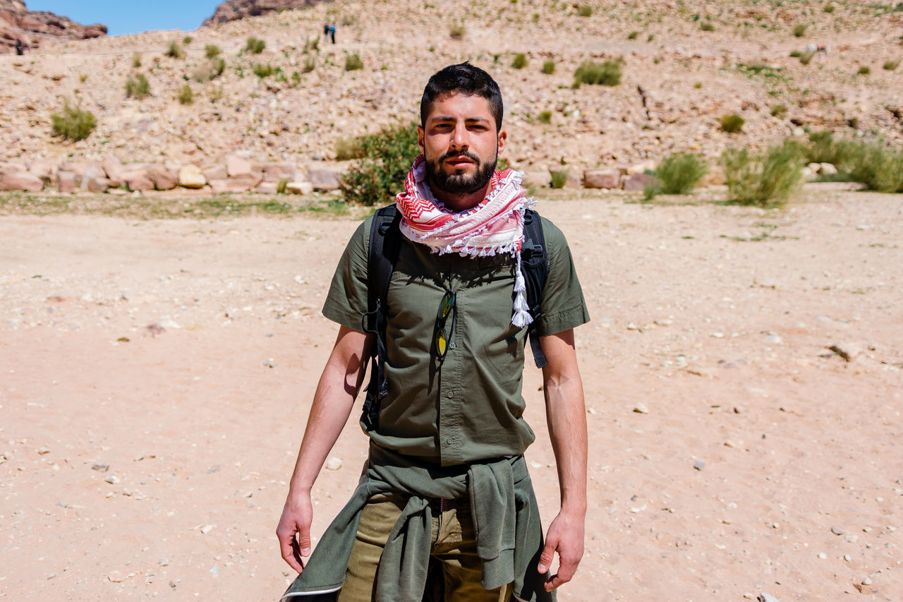 PORTRAIT OF MAN STANDING ON LAND