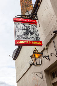 Low angle view of information sign against building