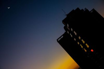 Low angle view of road sign against sky at night