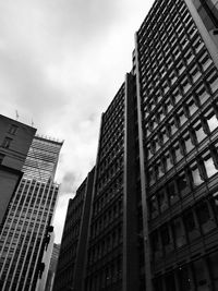 Low angle view of modern buildings in city against sky