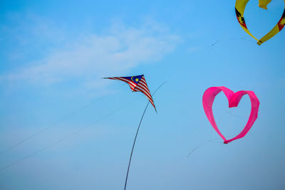 Low angle view of heart shape against sky