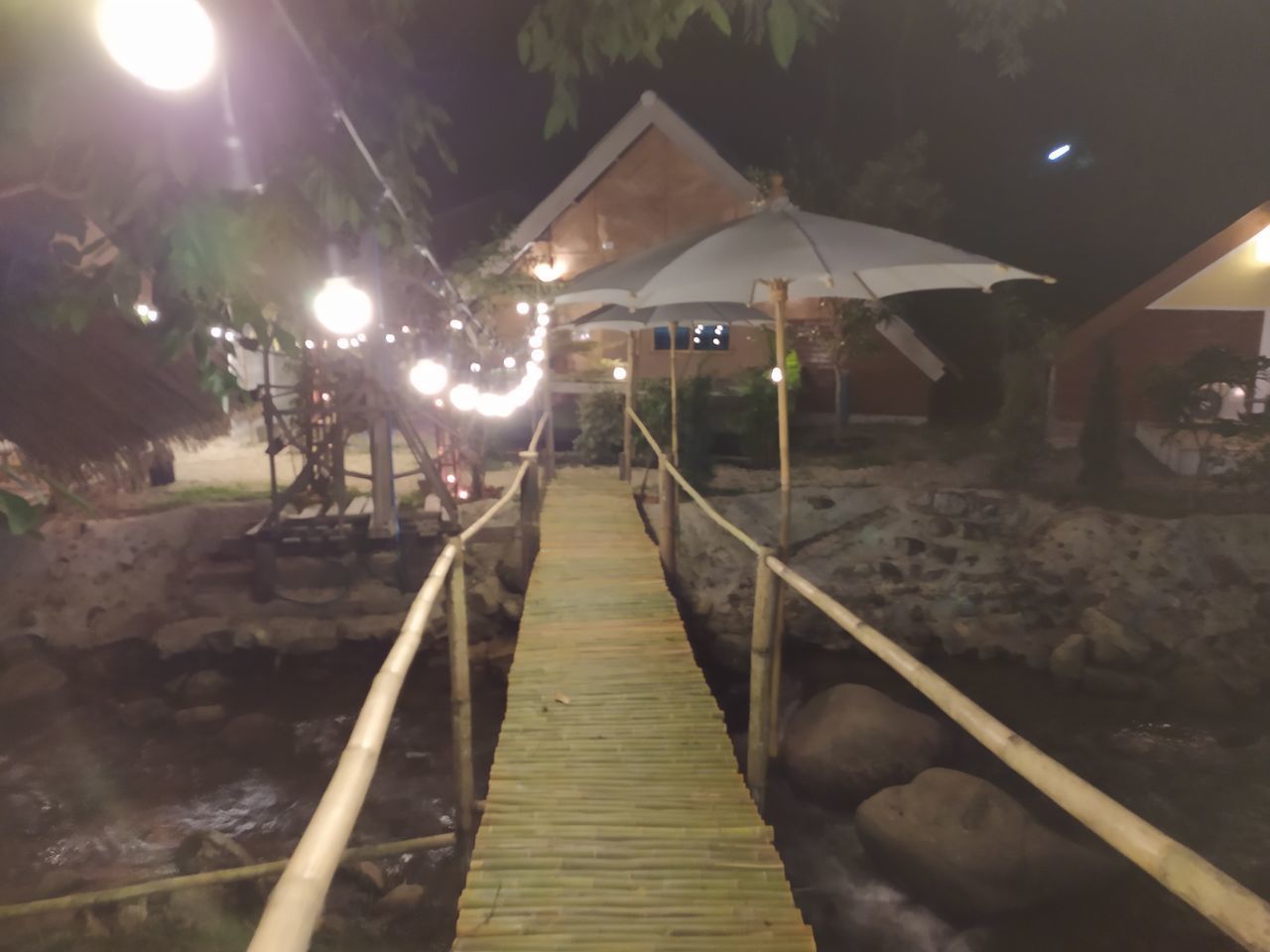 ILLUMINATED STREET LIGHT ON FOOTPATH BY RAILING