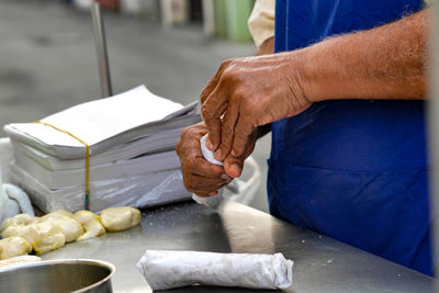 Midsection of man preparing food