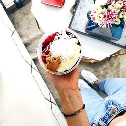 High angle view of hand holding ice cream