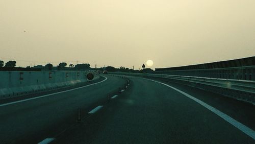 Highway against clear sky during sunset