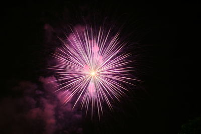 Low angle view of firework display at night