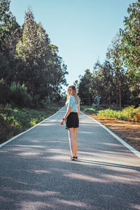 Full length of woman on road against sky