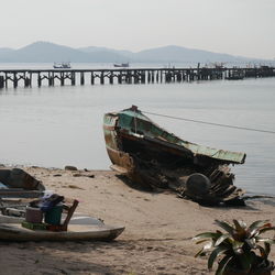 Boats moored on beach against sky