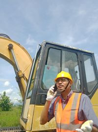 Portrait of mid adult man against yellow sky