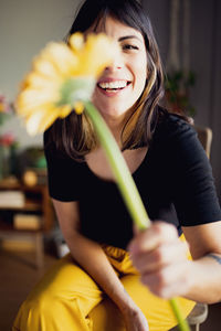 Portrait of young woman holding flower