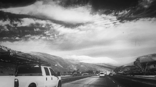 Scenic view of mountains against cloudy sky