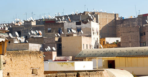 High angle view of buildings in town against sky