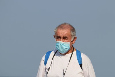 Portrait of a man against blue background