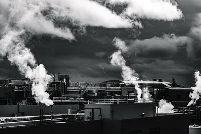 Smoke emitting from chimney against sky