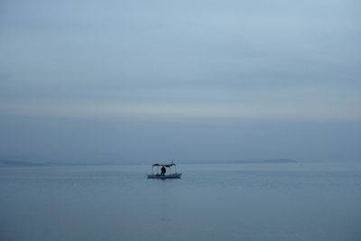 Sailboat in sea against sky