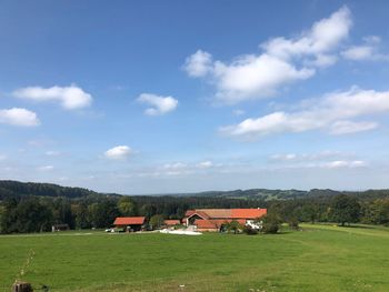 Houses on field against sky